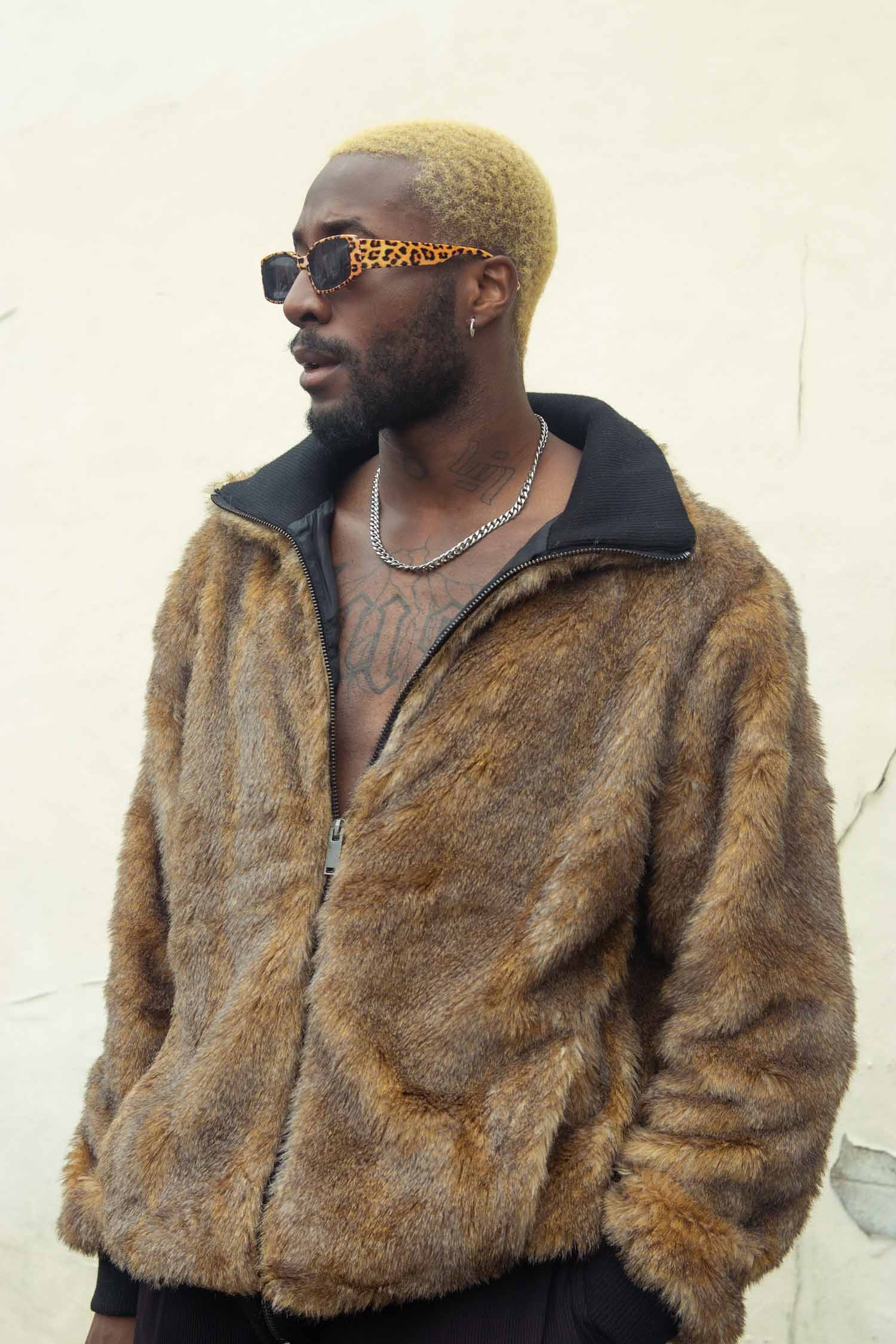 a person wearing sunglasses and a fur coat